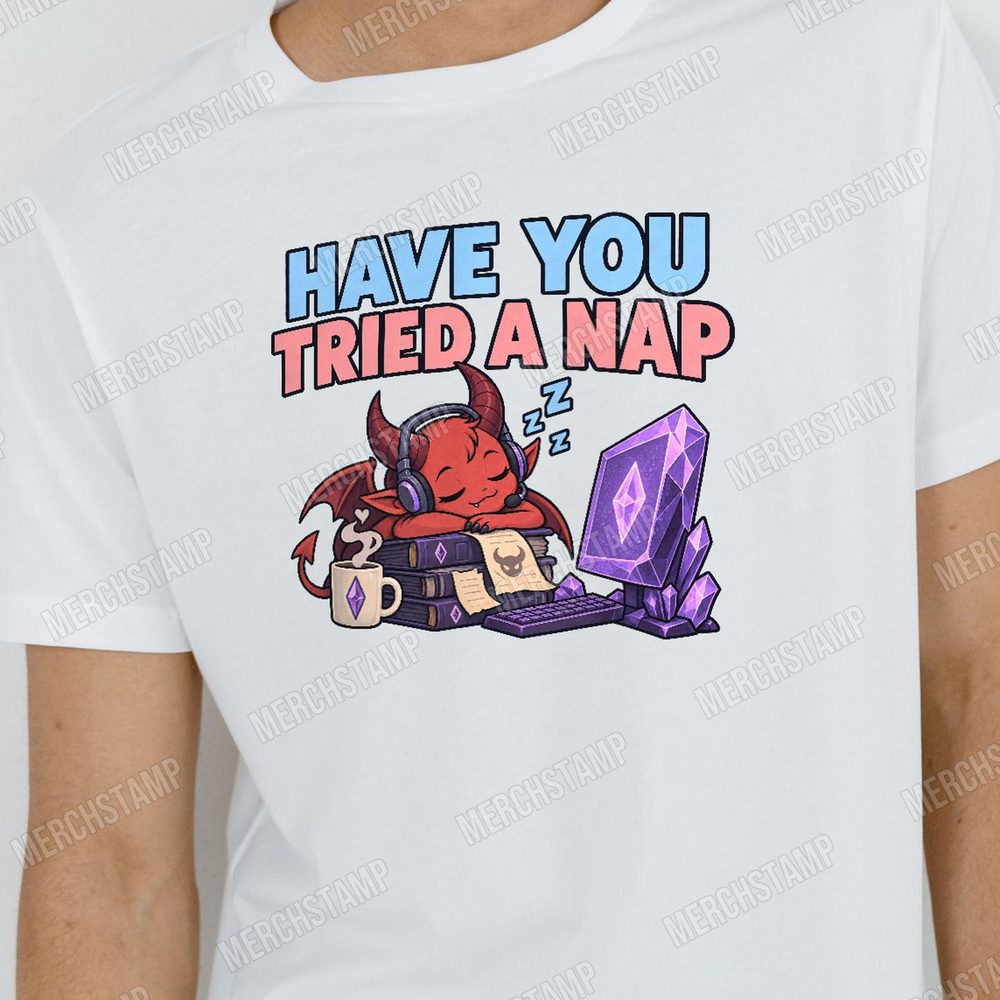 Have You Tried A Nap PNG design shown on a white t-shirt, a small red horned demon in headphones asleep on a stack of spellbooks under the words Have You Tried A Nap