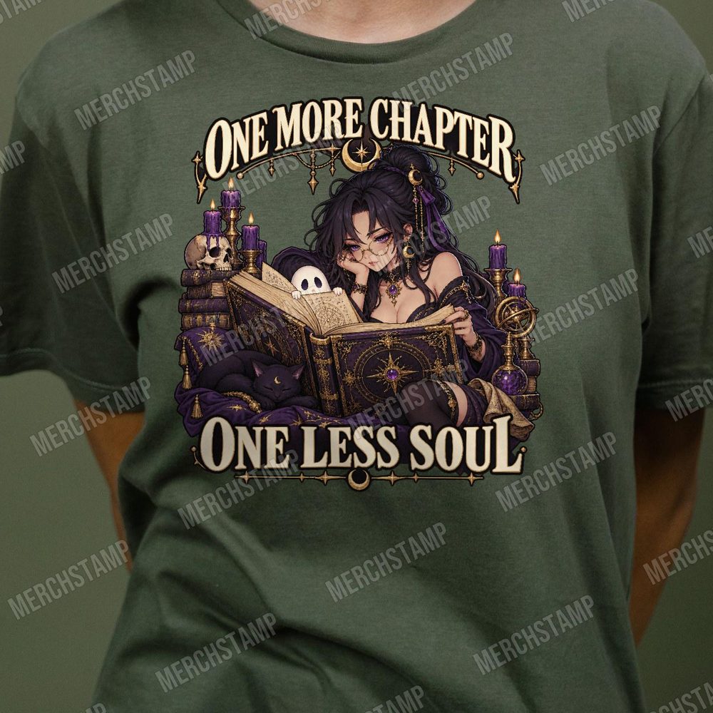 One More Chapter One Less Soul PNG design shown on an olive t-shirt, a gothic witch in round glasses reading a glowing spellbook by candlelight beside a black cat, between the words One More Chapter One Less Soul