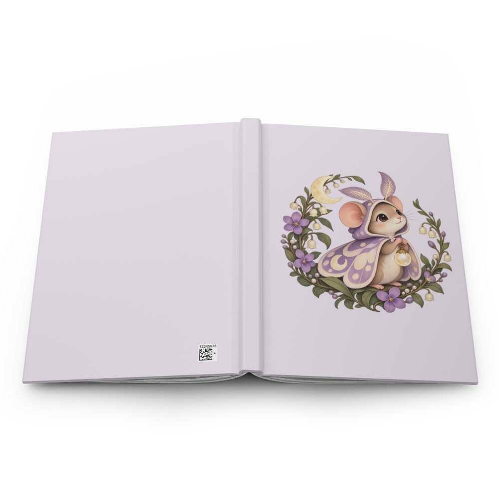 Moon Moth Mouse hardcover journal shown open flat, a mouse in a lavender moth-wing cape beside a crescent moon inside a wreath of lilac flowers on the front cover, with a lavender spine and back