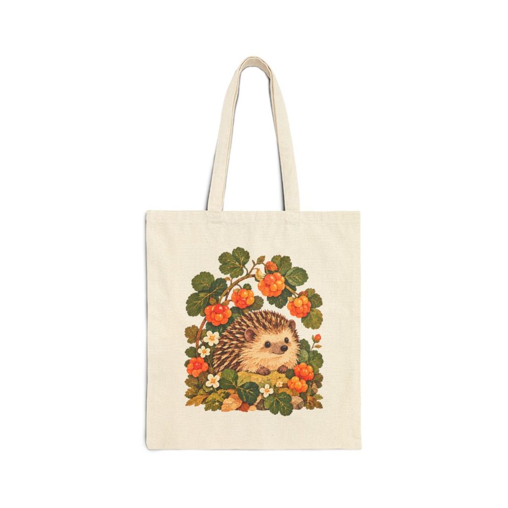 Hedgehog and Berries tote bag in natural cotton canvas, printed with a hedgehog tucked under an arch of orange berries, flowers and leaves
