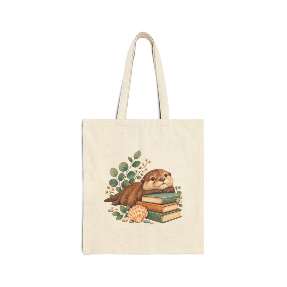 Otter and Books tote bag in natural cotton canvas, printed with a sleepy otter resting on a stack of books beside a seashell